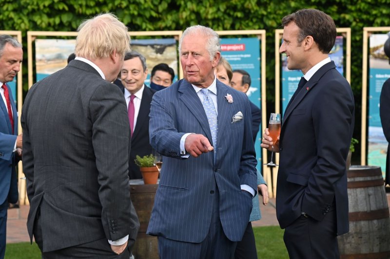 Then-Prince Charles speaks with British Prime Minister Boris Johnson and French President Emmanuel Macron during a reception and dinner hosted by the Eden Project in June in Cornwall, UK Charles became King Thursday immediately upon Queen Elizabeth II's death. Photo by Karwai Tang/G7 Cornwall 2021 | <a href="/News_Photos/lp/118224648537e84cf203d1a914b42d7b/" target="_blank">License Photo</a>
