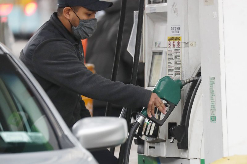A worker at a gasoline station puts gas in the car of a customer in New York City on Nov. 26, 2021. File Photo by John Angelillo/UPI | <a href="/News_Photos/lp/0ea73a98e54ca37d74d5fab6ecb7819b/" target="_blank">License Photo</a>