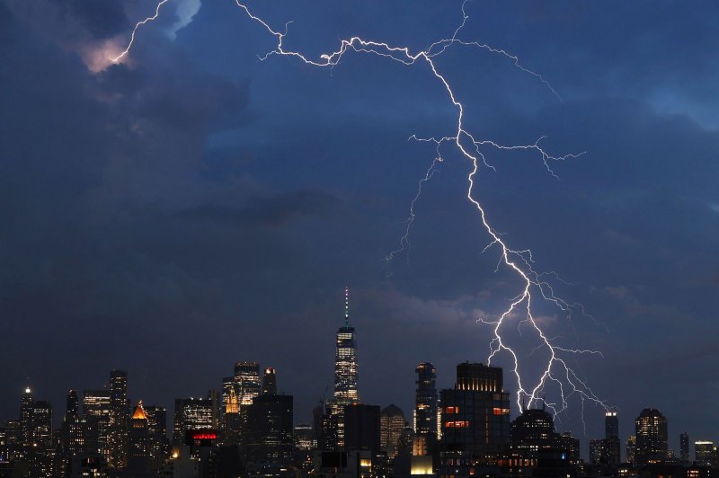 A bolt of lightning strikes behind One World Trade Center and the Manhattan Skyline in New York City on Thursday, August 4, 2022. Photo by John Angelillo/UPI | <a href="/News_Photos/lp/8b081280fb727ad55b35b5a55ffda4bc/" target="_blank">License Photo</a>