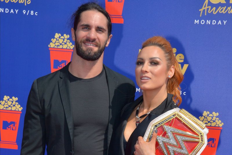 Raw Women's Champion Becky Lynch (R), and her husband, Seth Rollins, answered questions from staffers at "The Late Show with Stephen Colbert." File Photo by Jim Ruymen/UPI