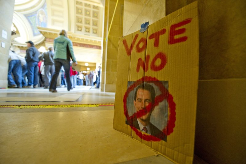 An sign against Wisconsin Gov. Scott Walker is left against a wall at the state Capitol in Madison, Wis., Feb. 24, 2011. UPI/Brian Kersey