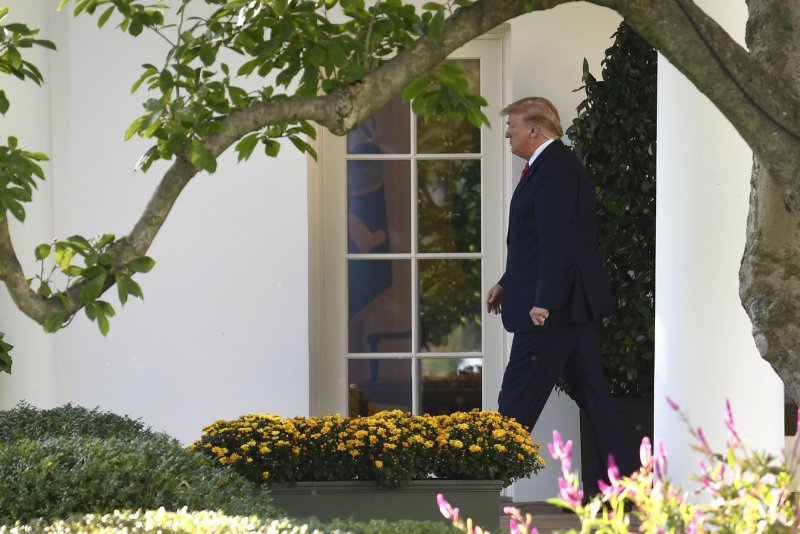 President Donald Trump walks outside the Oval Office at the White House Thursday as he departs for a campaign rally in Minneapolis, Minn. Photo by Mike Theiler/UPI