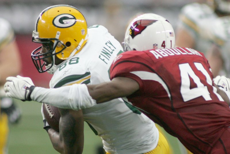 Green Bay Packers tight end Jermichael Finley (L) is about to get tackled by Arizona Cardinals Hamza Abdullah (R) after an 11-yard pick up in the second quarter. Abdullah went on a Twitter tirade against the NFL and its treatment of players. (UPI/Art Foxall)