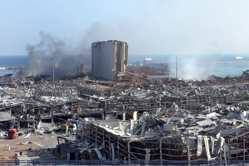 Debris and smoke is seen in the Port of Beirut, Lebanon, on August 5 following explosions that killed more than 200 people. Investigators later said ammonium nitrate that had been stored there set off the blasts. File Photo by Ahmad Terro/UPI