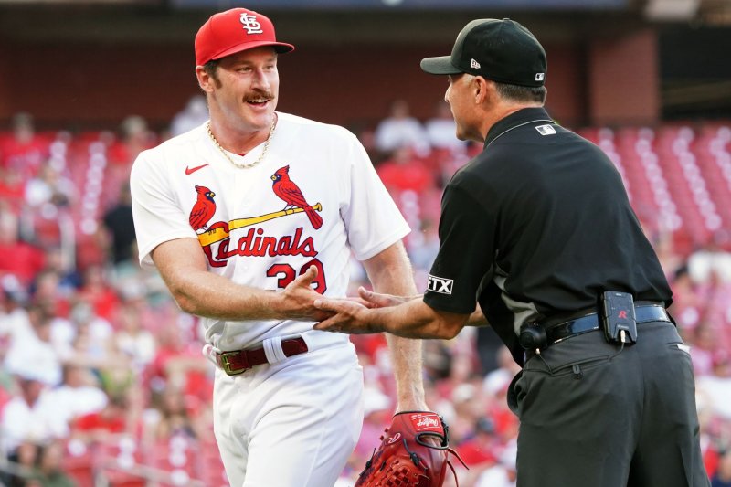 St. Louis Cardinals starting pitcher Miles Mikolas has his hand checked by first base umpire Dan Iassogna at the end of the second inning during Game 2 of a doubleheader against the Pittsburgh Pirates on Tuesday at Busch Stadium in St. Louis. Photo by Bill Greenblatt/UPI