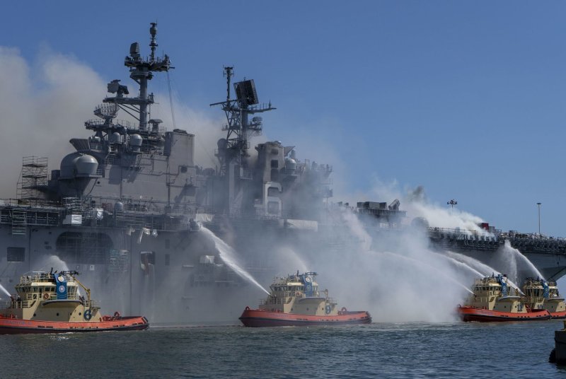 Firefighters work to extinguish a blaze aboard the USS Bonhomme Richard at Naval Base San Diego on July 12, 2020. Sailor Ryan Sawyer Mays faces an arson charge in his court martial, which began Monday in San Diego, Calif. File Photo by MC3 Christina Ross/U.S. Navy/UPI | <a href="/News_Photos/lp/7754b6fd0e6d51dd34e1c573167cded2/" target="_blank">License Photo</a>
