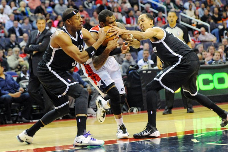 Washington Wizards forward Martell Webster (9) looses the ball against Brooklyn Nets forward Paul Pierce (L) and guard Shaun Livingston (R) in the first half at the Verizon Center in Washington, D.C. on March 15, 2014. UPI/Mark Goldman