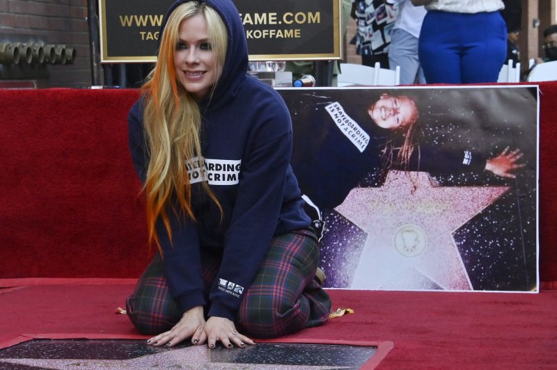 Canadian singer and songwriter Avril Lavigne strikes a poser during an unveiling ceremony honoring her with the 2,731st star on the Hollywood Walk of Fame. Photo by Jim Ruymen/UPI