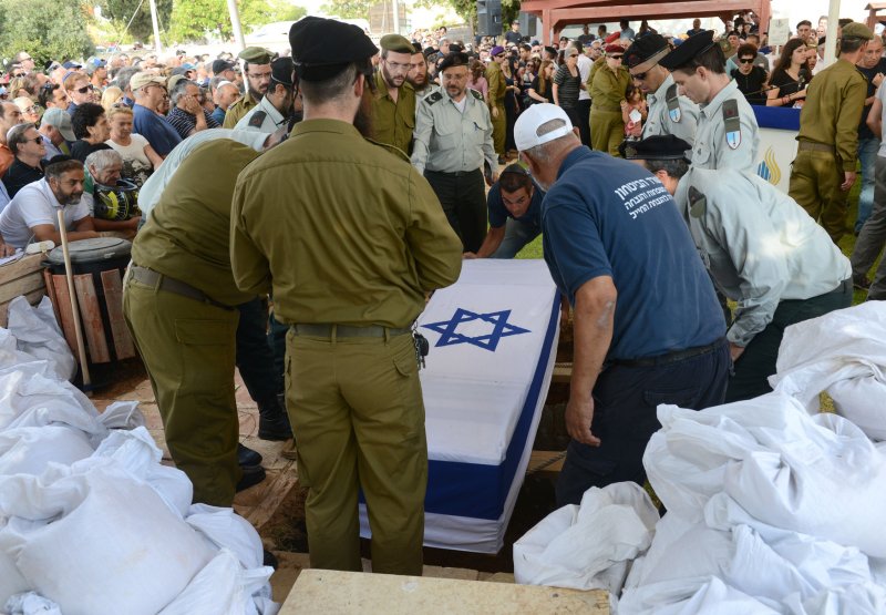 Israeli soldiers carry the flag covered coffin of Major Amotz Greenberg, 45, at a military funeral in the cemetery in Hod HaSharon, Israel, July 20, 2014. Greenberg, a reserve soldier, was killed in a fight with Palestinian militants in Gaza on Saturday. Eighteen Israeli soldiers and more than 350 Palestinians have lost their lives in the battle between Israeli forces and Hamas in Gaza. UPI/Debbie Hill