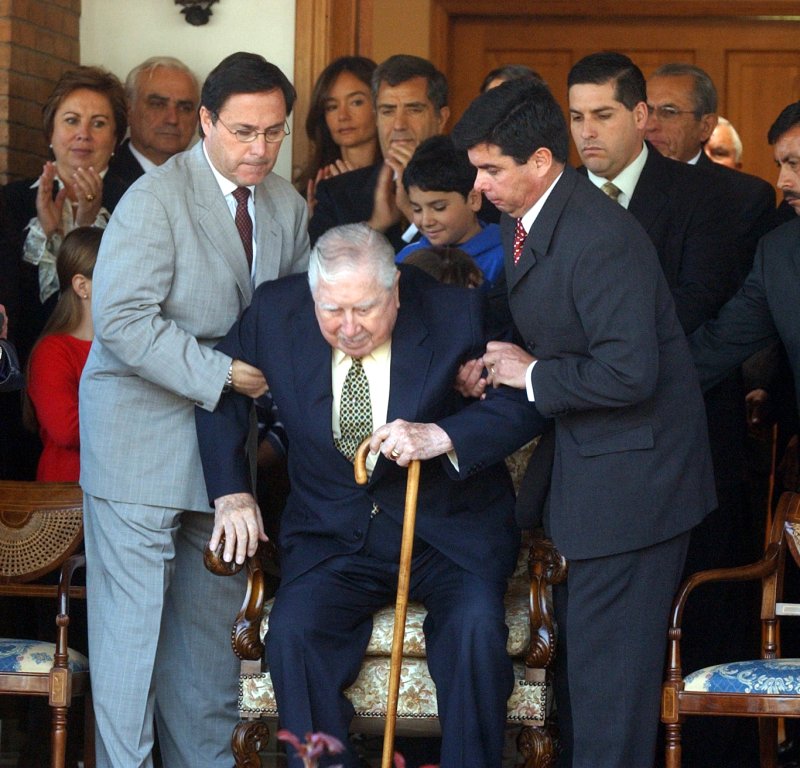 General Augusto Pinochet is greeted by followers at his residence in Santiago, Chile, on September 11, 2003. Pinochet and his collaborators celebrated the 30th anniversary of the military coup that overthrew the "Unidad Popular" regime headed by socialist Salvador Allende on September 11, 1973. File Photo by Robert Reveco/UPI