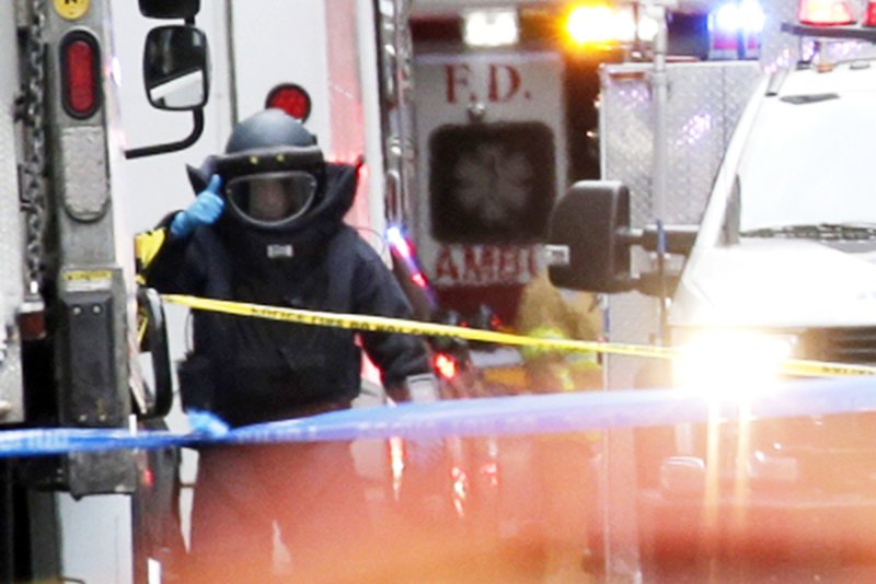 A bomb squad worker gives a thumbs up after a suspicious package which turned out to be an explosive device was discovered in a New York Post Office which was addressed to former Director of National Intelligence James Clapper and CNN on 52nd Street in New York City on October 26, 2018. The first of several such packages was found mailed to George Soros on October 22, 2018. File Photo by John Angelillo/UPI