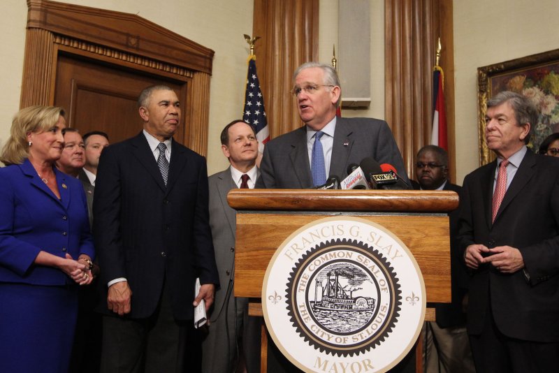 Missouri Gov. Jay Nixon flanked by other elected officials, makes remarks after the announcement that the National Geospatial-Intelligence Agency plans to stay in St. Louis and build a new North St. Louis City site worth $1.75 billion. The announcement comes after a competitive bidding process that included a site in neighboring Illinois. Photo by Bill Greenblatt/UPI