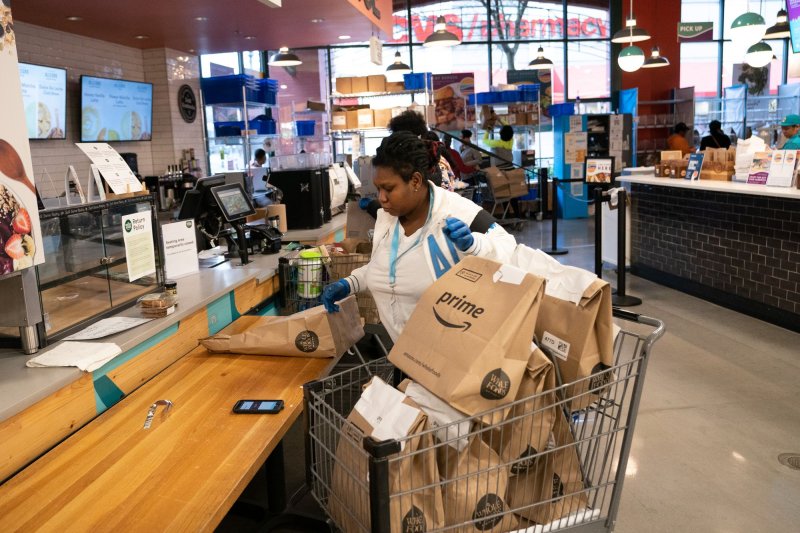 A contractor arranges Amazon Prime groceries at a Whole Foods Market in Silver Spring, Md., on March 31. The same day, a workers group encouraged employees to call out sick to demand improved safety and benefits during the coronavirus crisis. File Photo by Kevin Dietsch/UPI