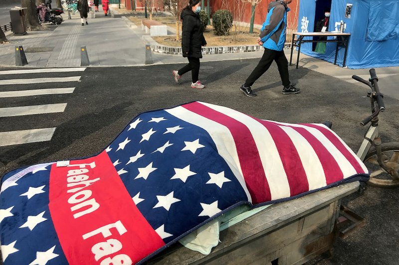 A rug with the design of the American flag covers a tricycle full of cabbage near a coronavirus checkpoint in Beijing on Wednesday.&nbsp; China is one many foreign policy challenges faced by President Joe Biden. Photo by Stephen Shaver/UPI
