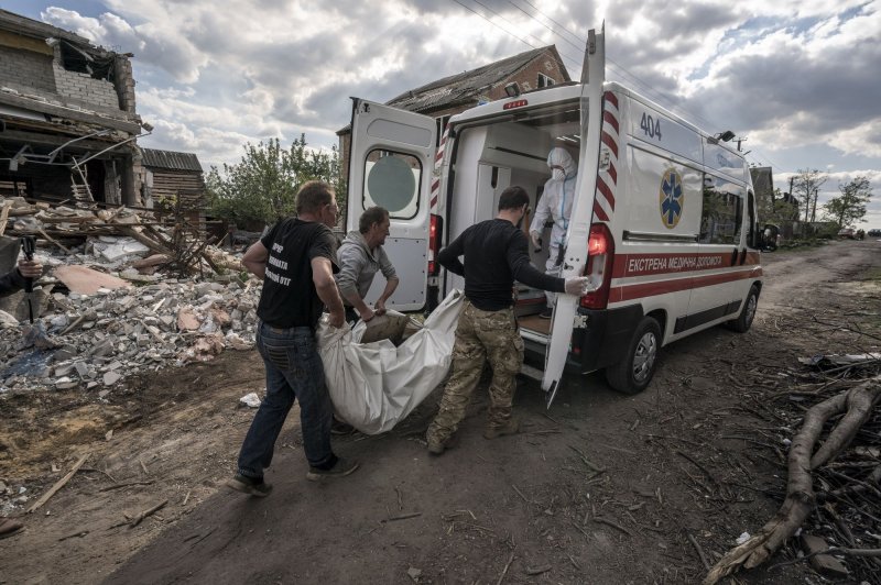 The body of a dead Russian soldier is placed into an ambulance in Mala Rohan, Ukraine, on May 19. A Ukrainian official said on Thursday that "tens of thousands" of people have died in the fighting so far. Photo by Ken Cedeno/UPI