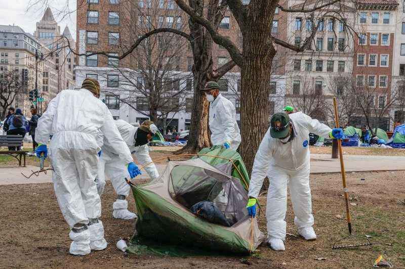 Workers from the National Park Service remove a tent as they begin to clear out a homeless camp at McPherson Square Park on Wednesday in Washington. Photo by Jemal Countess/UPI