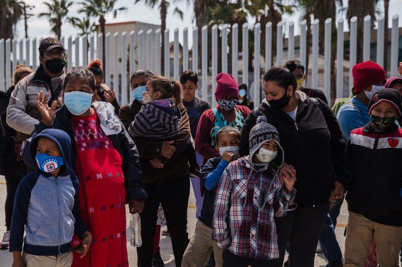 Asylum seekers demonstrate at the San Ysidro border crossing in Tijuana, Mexico, &nbsp;praying and listening to speeches on March 26. On Wednesday, the Biden administration said it wants to streamline the asylum process to ease a backlog of cases. File Photo by Ariana Drehsler/UPI