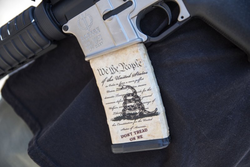 The U.S. Constitution is seen on an ammunition magazine in an assault-style rifle at a demonstration in Dallas on May 5, 2018. On Thursday, the U.S. Supreme Court ruled that Americans can legally carry guns outside the home. File Photo by Sergio Flores/UPI | <a href="/News_Photos/lp/f1bc2d7ef44c364459a0782e99b81fed/" target="_blank">License Photo</a>