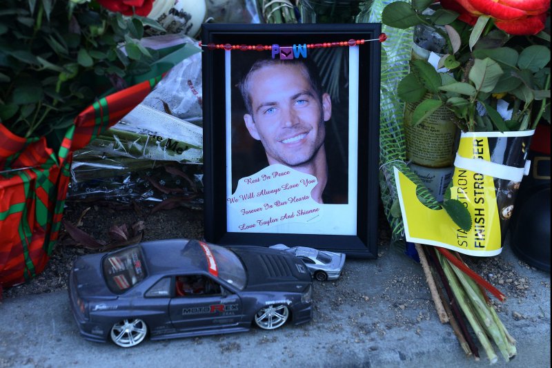 Fans gather at a makeshift memorial to pay respects at the site of the fiery car accident in which actor Paul Walker was killed in Santa Clarita, California, on December 4, 2013. Fans and fellow actors mourned the death of Paul Walker, who died in a fiery car crash on Saturday, December 1, 2013. Walker, 40, who was best known as undercover agent Brian O'Connor in the "Fast and Furious" action movies, appeared in all but one of the six movies in the popular franchise, and was a leading protagonist along with Vin Diesel and Michelle Rodriguez. UPI/Jim Ruymen