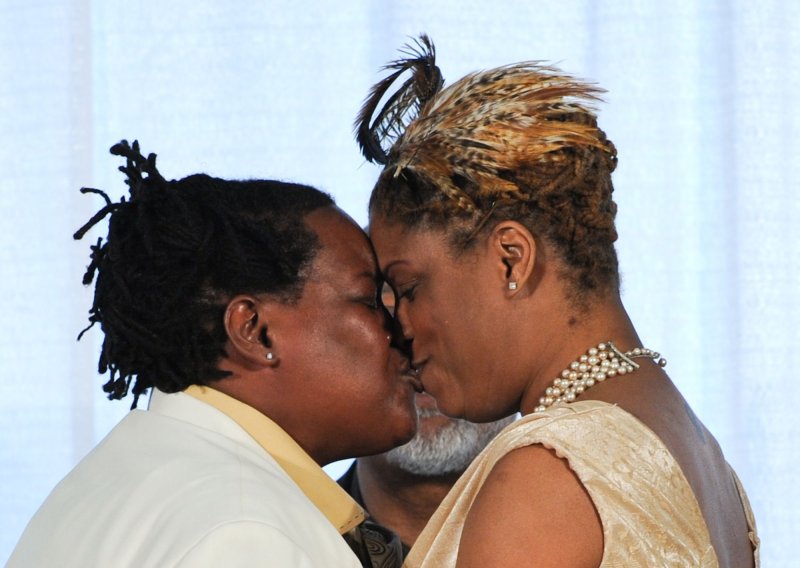 Angelisa Young (R) and Sinjolya Townsend, the first gay couple to wed in the District of Columbia, kiss after they exchanged vows at their wedding ceremony at the Human Rights Campaign building in Washington on March 9, 2010. In December 2009, the DC Council approved a bill that would allow for same-sex marriages to be performed in the District. Today, same-sex couples were able to obtain marriage licenses they applied for last week and proceed with wedding ceremonies. UPI/Alexis C. Glenn