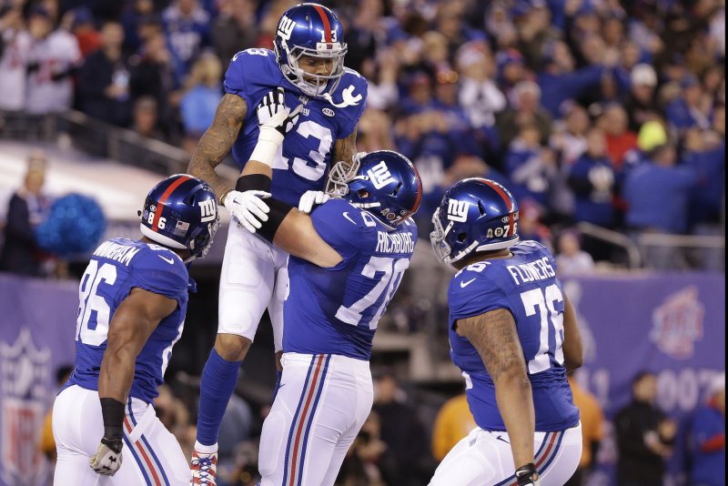 New York Giants Odell Beckham Jr. celebrates with teammates in the end zone after catching an 87 yard touchdown pass in the first quarter against the New England Patriots at MetLife Stadium in East Rutherford, New Jersey on November 15, 2015. Photo by John Angelillo/UPI