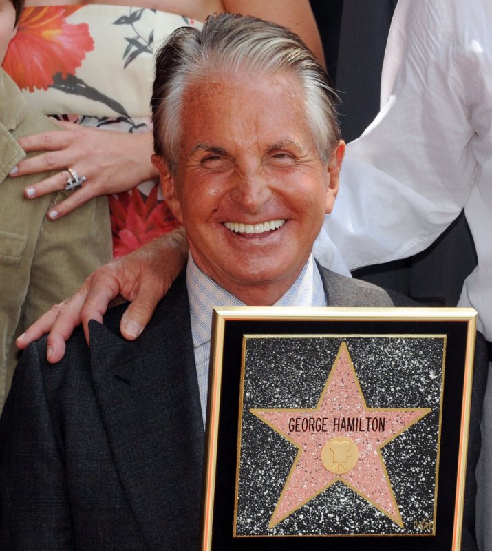 Actor George Hamilton saviors the moment after accepting a star on the Hollywood Walk of Fame in Los Angeles on August 12, 2009. Hamilton, who received the 2,388th star during an unveiling ceremony attended by friends, fans and family members, also celebrated his 70th birthday. UPI Photo/Jim Ruymen