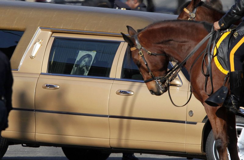 A gold hearse with a picture of Whitney Houston on the window pulls away from The New Hope Baptist Church for the Funeral of Whitney Houston in Newark, New Jersey on February 18, 2012. UPI/John Angelillo