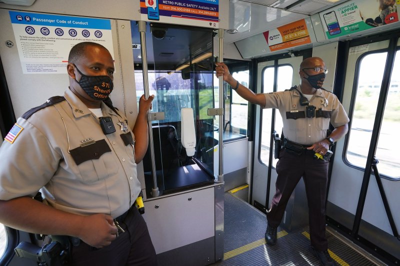 Masked sheriff's deputies are seen Tuesday while riding a commuter train in St. Louis. Mo. Missouri is one of several states Dr. Anthony Fauci said are at an increased risk of seeing a surge in coronavirus cases.&nbsp; Photo by Bill Greenblatt/UPI