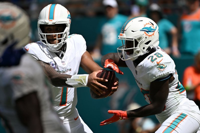 Miami Dolphins quarterback Tua Tagovailoa (L) hands off the ball to running back De'Von Achane in the second quarter against the New York Giants on Sunday at Hard Rock Stadium in Miami Gardens, Fla. Photo by Larry Marano/UPI