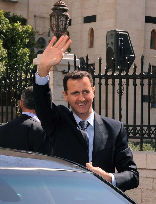 Syrian President Bashar al-Assad waves to supporters in the street after addressing parliament on March 30, 2011 in Damascus, Syria. UPI