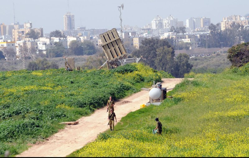 Israeli soldiers walk near the Israeli anti-missile system known as Iron Dome, used to intercept rockets fired by Palestinian militants from the Gaza Strip, in Ashdod, Israel, March 11, 2012. More than 120 rockets have been fired at Israel from Gaza since Friday, while the Iron Dome system has intercepted more than 30 rockets. The deadliest clashes between the two sides in over a year have entered their third day showing no signs of subsiding. UPI/Debbie Hill