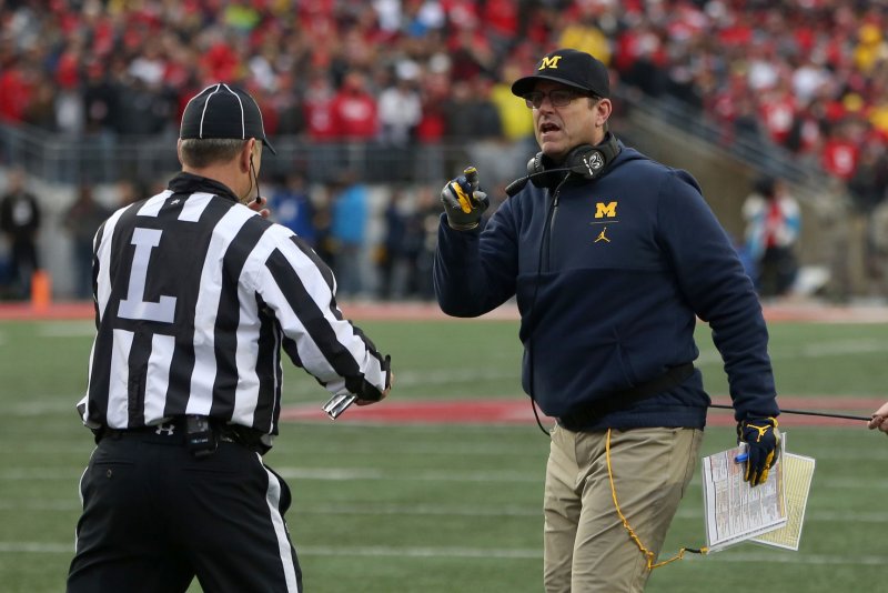 Michigan head coach Jim Harbaugh talks to the line judge during game against Ohio State on November 24 in Columbus, Ohio. Photo by Aaron Josefczyk/UPI