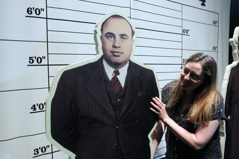 Amanda Bailey with the Missouri History Museum adjusts a cutout figure of Al Capone in St. Louis on April 22, 2014. On January 25, 1947, Capone died at age 48 after suffering from syphilis. File Photo by Bill Greenblatt/UPI