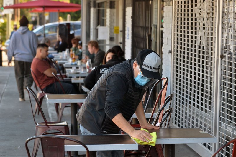 Patrons sit in an outdoor dining area at Millie's Cafe on Sunset Boulvard in Los Angeles on&nbsp; Saturday. Los Angeles County lifted it's ban on outdoor dining after a lengthy public health closure. Photo by Jim Ruymen/UPI.