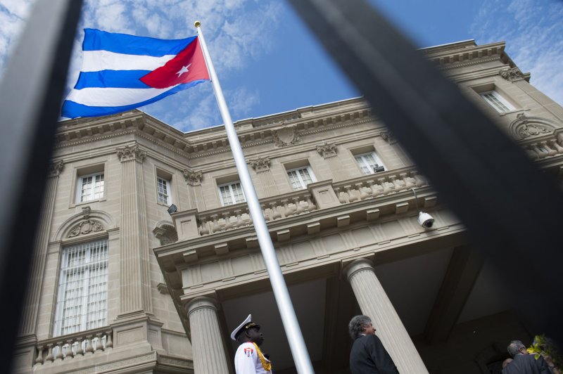 A Cuban national flag is raised in 2015 during a ceremony to reopen the Cuban government's embassy to the United States in Washington, D.C.. Friday during a trip to Miami, President Donald Trump is expected to announce rollbacks to existing U.S. policies toward the island nation established by former President Barack Obama. File Photo by Kevin Dietsch/UPI | <a href="/News_Photos/lp/9f6532e76d19eb510b86bafb5709e294/" target="_blank">License Photo</a>