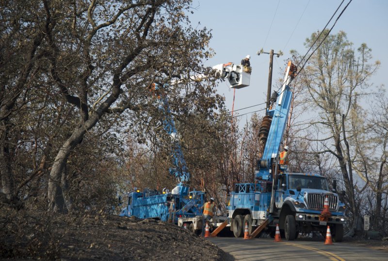 A Pacific Gas and Electric crews work to restore power on Atlas Peak road in Napa, Calif., on October 17. PG&E preemptively cut off power to 60,000 customers Sunday night, citing dangerous fire conditions. File Photo by Terry Schmitt/UPI | <a href="/News_Photos/lp/65f95d9cce2794df95696549dfdad8bc/" target="_blank">License Photo</a>