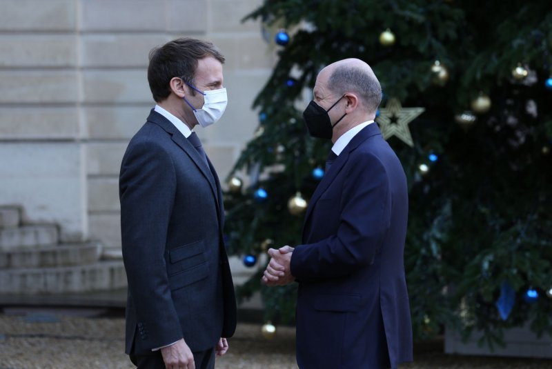 French President Emmanuel Macron (L) greets German Chancellor Olaf Scholz as he arrives at the Elysee Palace in Paris on Friday. Photo by David Silpa/UPI