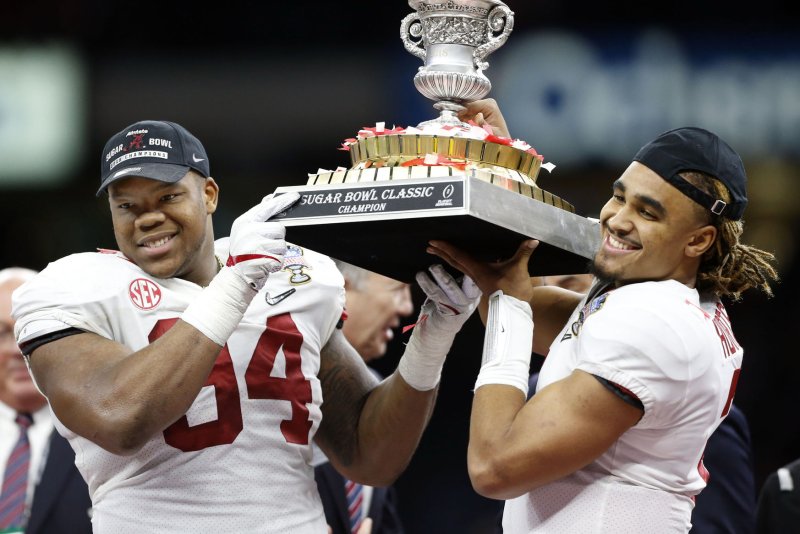 Alabama Crimson Tide defensive lineman Da'Ron Payne (94) and Alabama Crimson Tide quarterback Jalen Hurts (2) lift the Sugar Bowl trophy after beating the Clemson Tigers in the Allstate Sugar Bowl on January 1, 2018 at the Mercedes-Benz Superdome in New Orleans. Photo by AJ Sisco/UPI