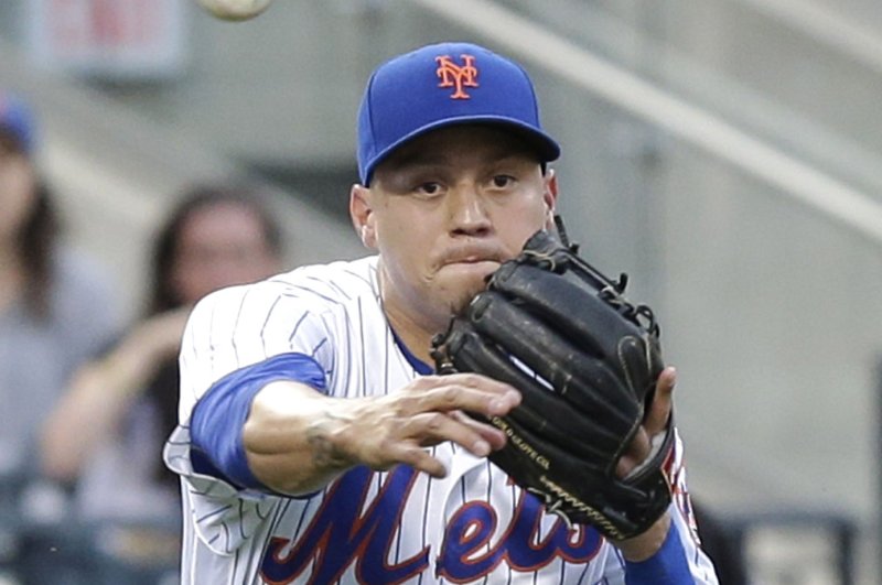 New York Mets' Wilmer Flores throws to first base in the 2nd inning against the Pittsburgh Pirates at Citi Field in New York City on June 15, 2016. Photo by John Angelillo/UPI