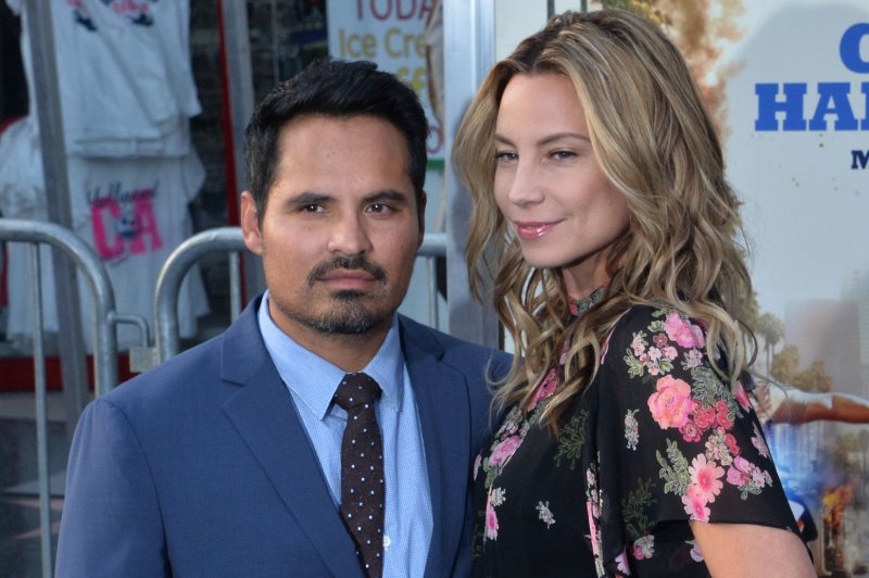 Michael Pena (L) with his wife Brie Shaffer. The actor has been cast in the "Dora the Explorer" live-action film starring Isabela Moner. File Photo by Jim Ruymen/UPI