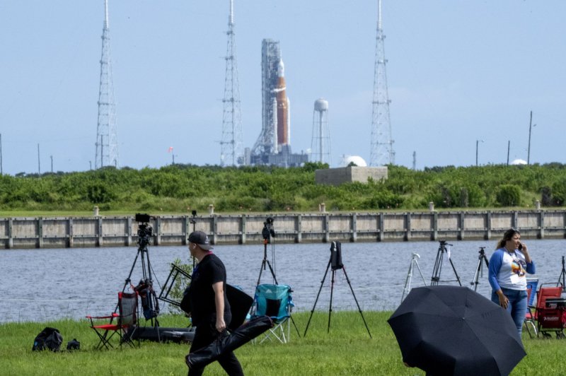 People leave after the launch attempt of Artemis I, in the background on Launch Pad 39B, was scrubbed at Kennedy Space Center in Florida on Saturday. Photo by Pat Benic/UPI