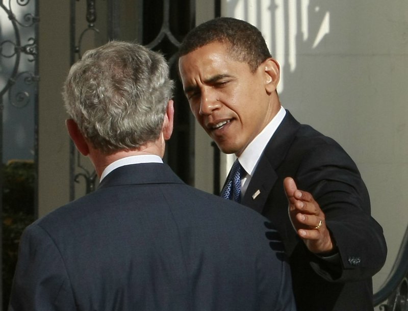 President-elect Barack Obama (R) greets U.S. President George W. Bush as Ob...