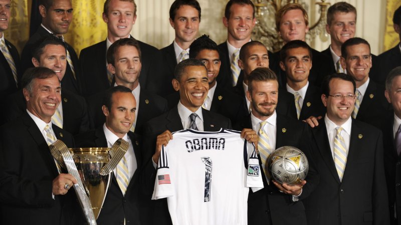 US President Barack Obama poses with a souvenir jersey as he is flanked by players David Beckham (R) and Landon Donovan (L), members of the LA Galaxy, Major League Soccer's Championship team at the White House, May 15, 2012, in Washington, DC. UPI/Mike Theiler | <a href="/News_Photos/lp/c8fc525a09e3ee7cafaeb5833917cc66/" target="_blank">License Photo</a>