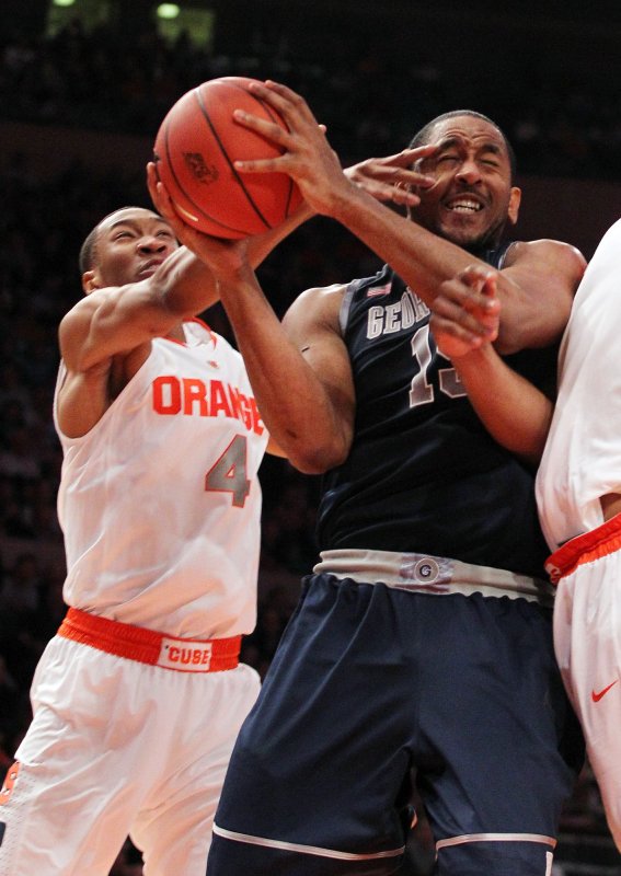 Georgetown Hoyas Austin Freeman gets poked by Syracuse Orange Wes Johnson fighting for a rebound in the second half at the NCAA Big East Basketball Championship at Madison Square Garden in New York City on March 11, 2010. Georgetown defeated Syracuse 91-84. UPI/John Angelillo