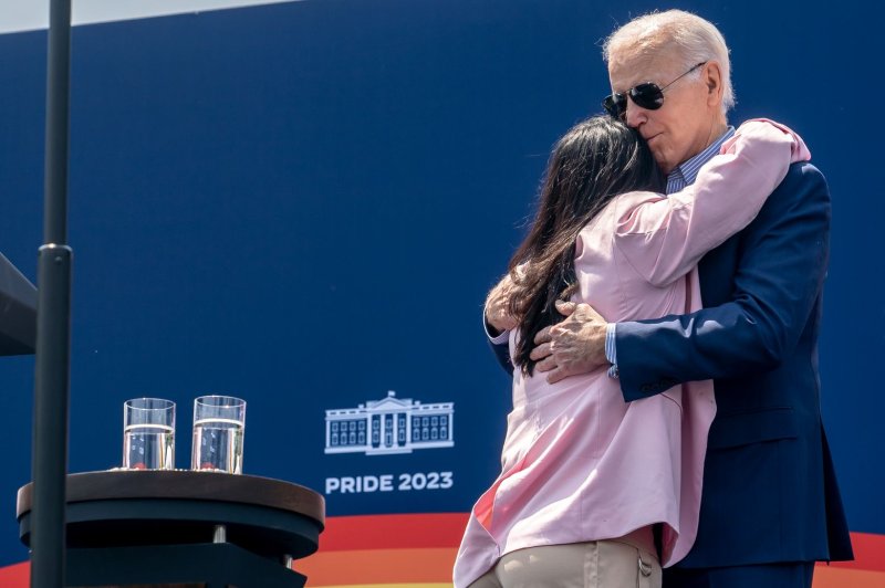 President Joe Biden hugs Scarlett Harvey, a health and fitness coach from Houston, during a Pride Month celebration event at the White House on Saturday. Photo by Nathan Howard/Bloomberg/UPI