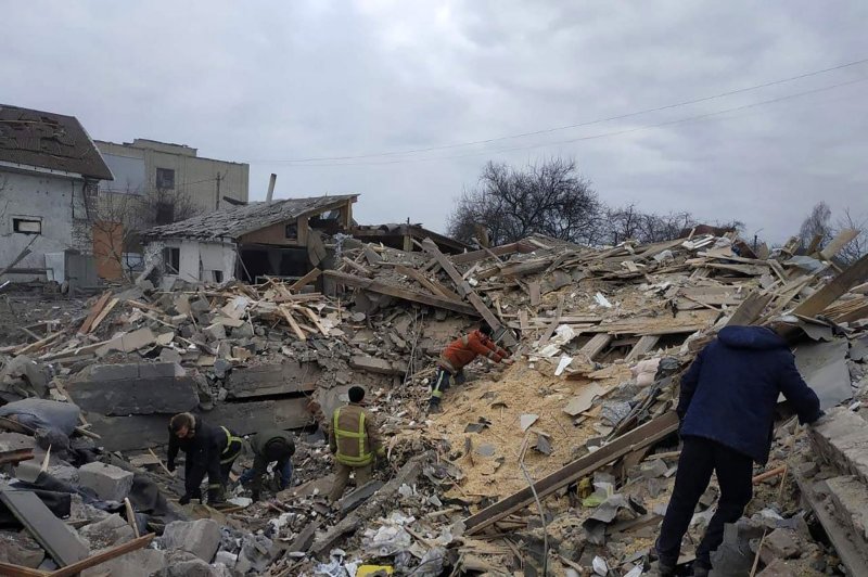 People walk among debris from residential buildings damaged by a shelling in the Zhytomyr region amid the Russian invasion of Ukraine on Monday. Photo courtesy of Ukrainian State Emergency Service/UPI