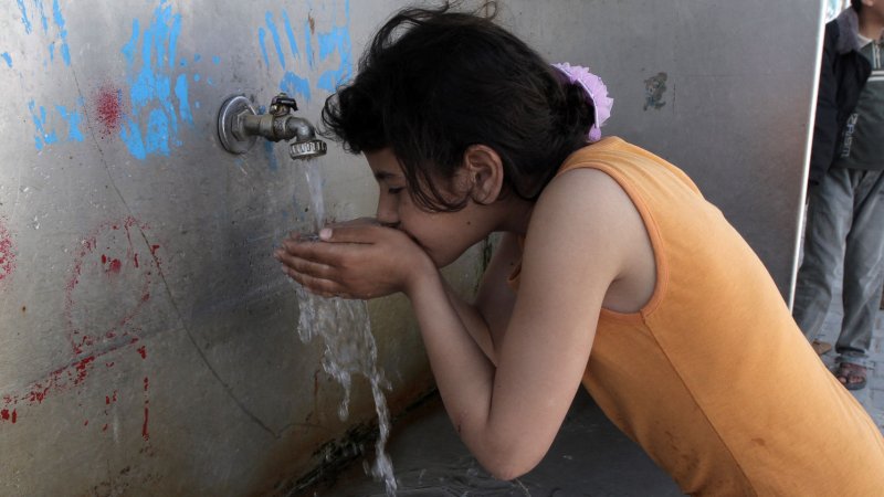 A Palestinian child drinks water in the southern Gaza Strip refugee camp of Rafah on April 08, 2012. Israelis use 66 gallons a day, while Palestinians are limited to 15.4 gallons, even though they claim a major underground aquifer and access to Jordan River. UPI/Ismael Mohamad