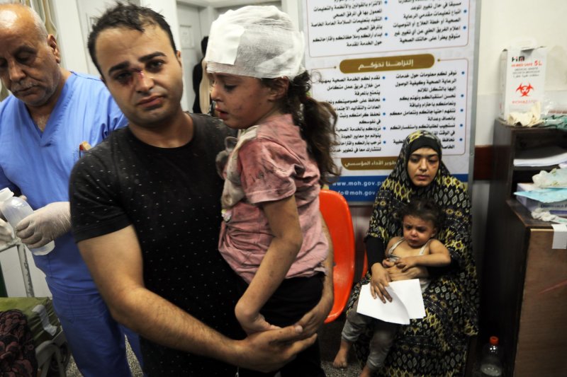 A Palestinian family waits for medical help at the Najjar hospital after an Israeli air strike on a home in Rafah, in the southern Gaza Strip, on Monday. Israeli Prime Minister Benjamin Netanyahu rejected global calls for a humanitarian cease-fire, citing threats posed by the Hamas militant group. Photo by Ismael Mohamad/UPI