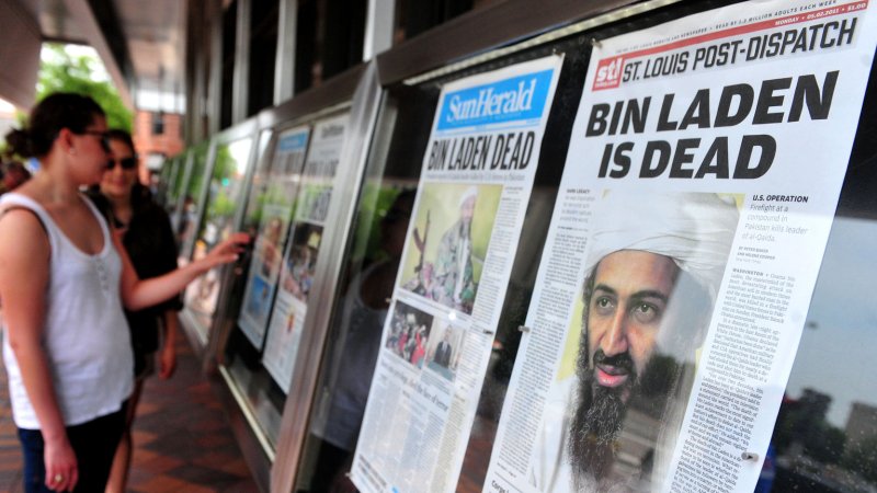 People stop to look at the front page headlines from around the country that announce the death of Al-Qaida terror leader Osama bin Laden in front of the Newseum in Washington on May 2, 2011. UPI/Kevin Dietsch