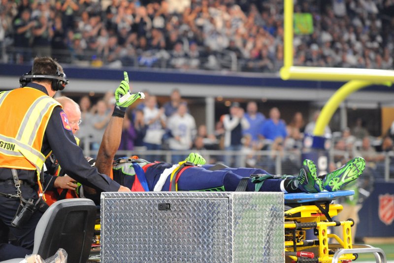 Seahawks wide receiver Ricardo Lockette signals to fans as he is taken off the field on a stretcher after receiving a blindside hit from Cowboys safety Jeff Heath at AT&T Stadium on November 1, 2015 in Arlington, Texas. File Photo by Ian Halperin/UPI | <a href="/News_Photos/lp/8833cb5427002063d4d249f40cf1db64/" target="_blank">License Photo</a>